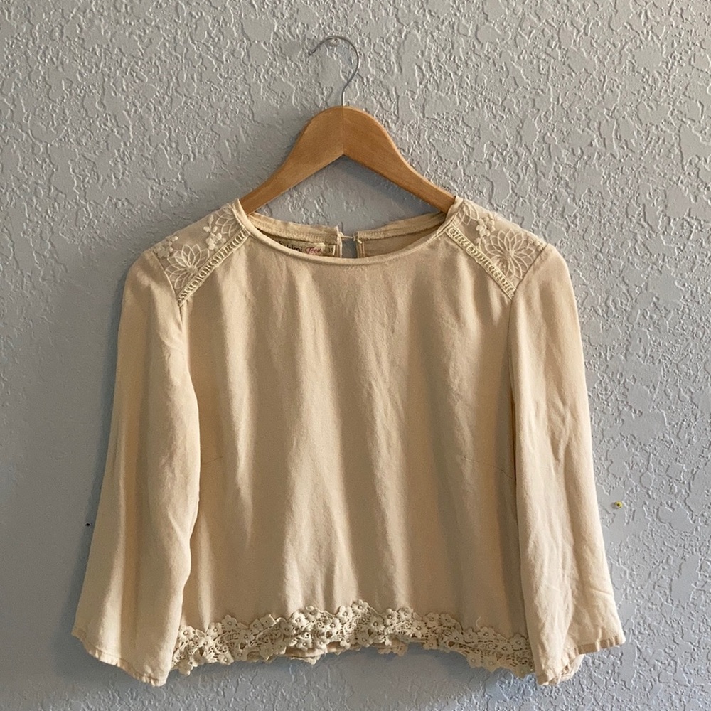 Light cream top with floral lace trim size small
